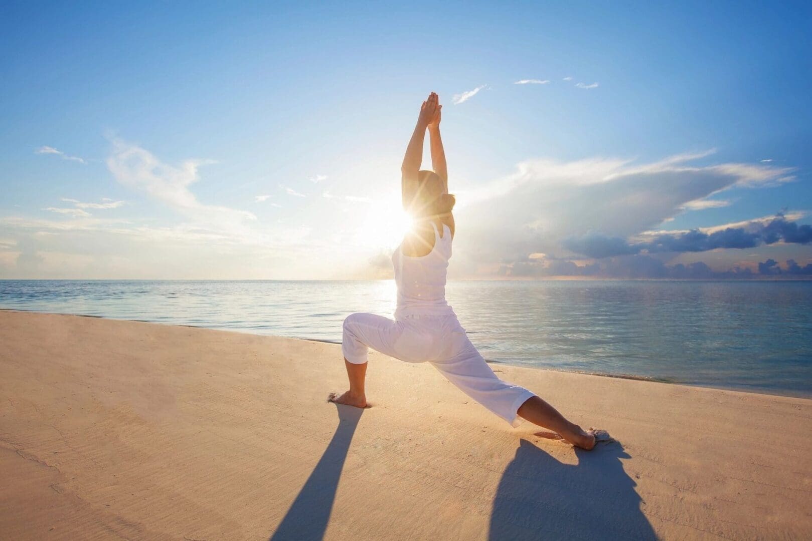 A person is doing yoga on the beach