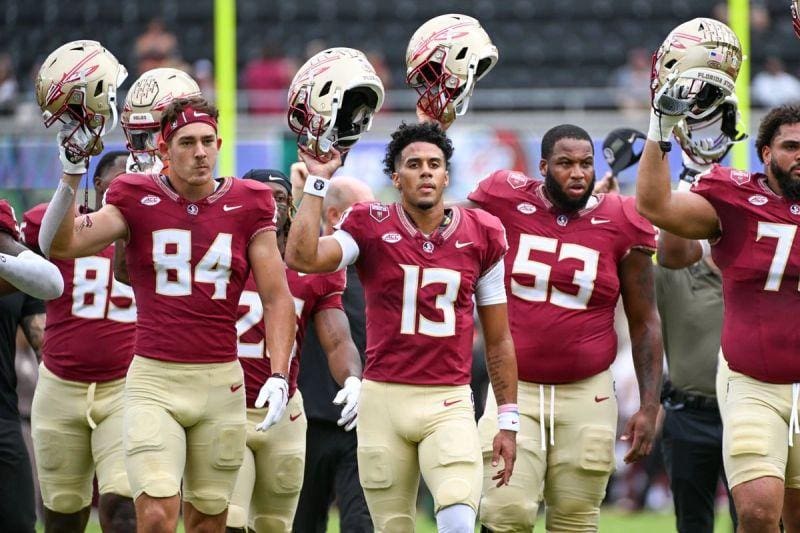 A group of football players walking on the field