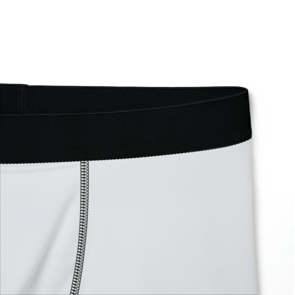 A close up of the bottom of a pair of white boxers.