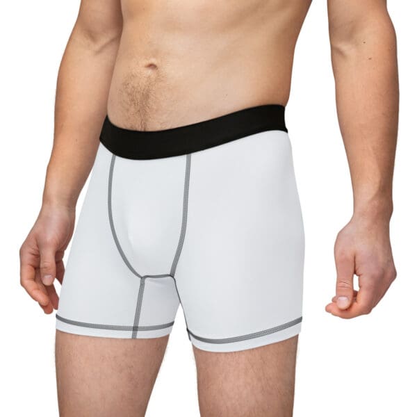 A man wearing white underwear with black trim.