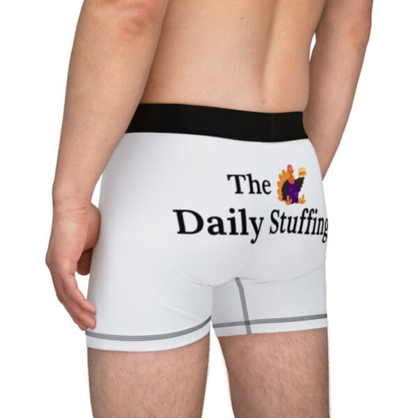 A man wearing white boxers with the daily stuffing logo.