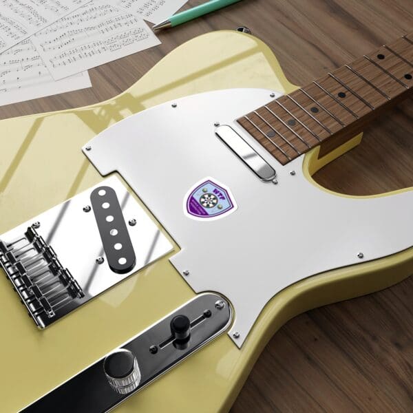 A yellow guitar sitting on top of a wooden table.